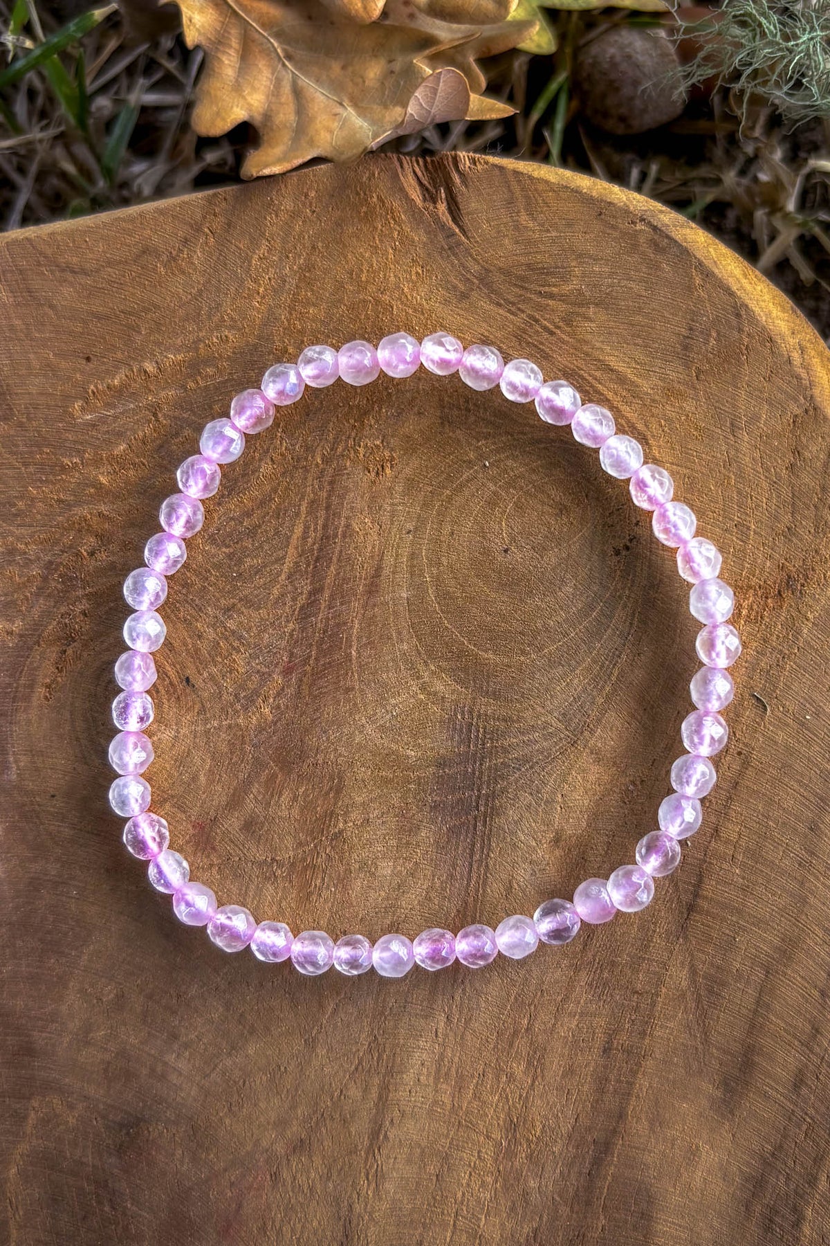 Pulsera cuarzo rosa facetado 4mm sobre madera